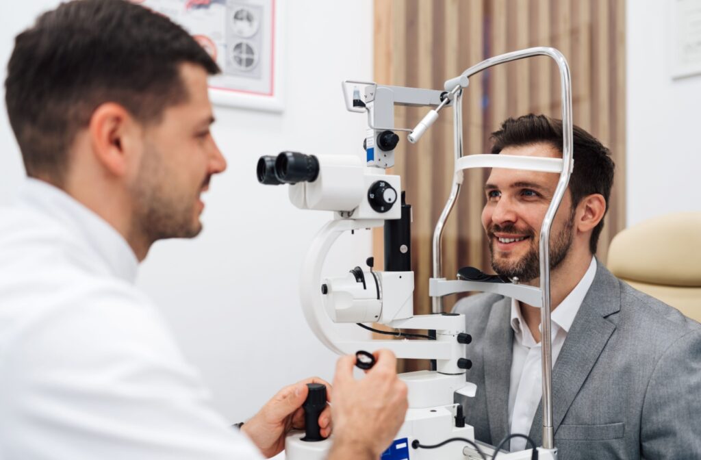 A patient getting ready to get his eyes examined with a slit lamp by his eye doctor.