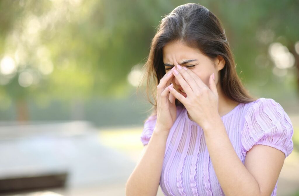Closeup of someone rubbing their eyes in discomfort.