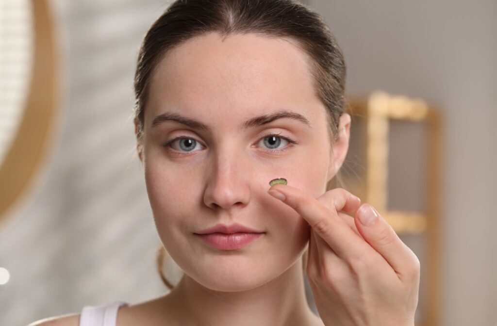 A person putting in a contact lens that is good for dry eyes