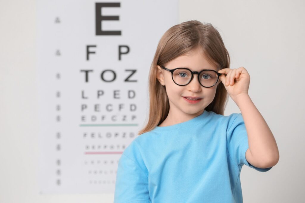 A child wearing glasses for myopia at the eye doctors